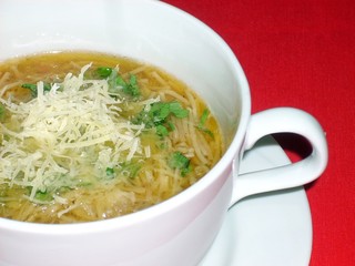 Soup with rice noodles with parmesan cheese on vegetable broth
