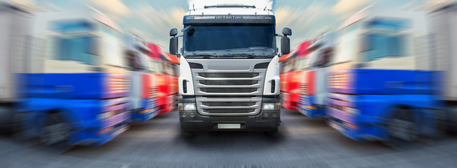 truck goes along ranks of trucks