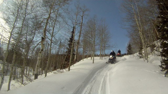 Snowmobile following winter mountain forest P HD 0030