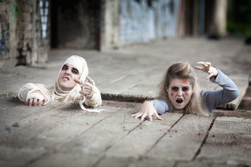Zombie and mummy coming out of the basement