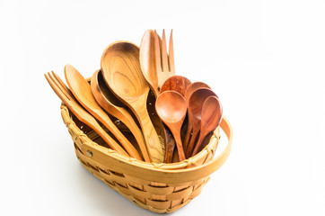 old retro wooden spoon and fork in wicker basket on white background