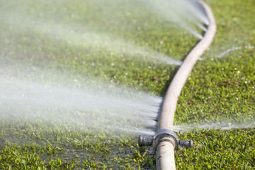 wasting water - water leaking from hole in a hose