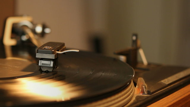 Close up HD movie of a record player playing a vinyl black record. 