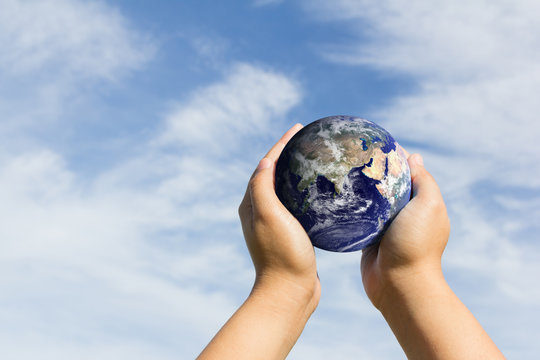 hands holding blue earth. Elements of this image furnished by NA