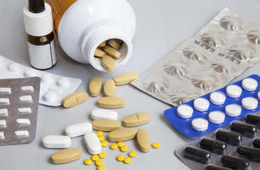 Many pills in a bottle and medicine capsule