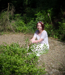 Naklejka na ściany i meble woman sitting in a forest III