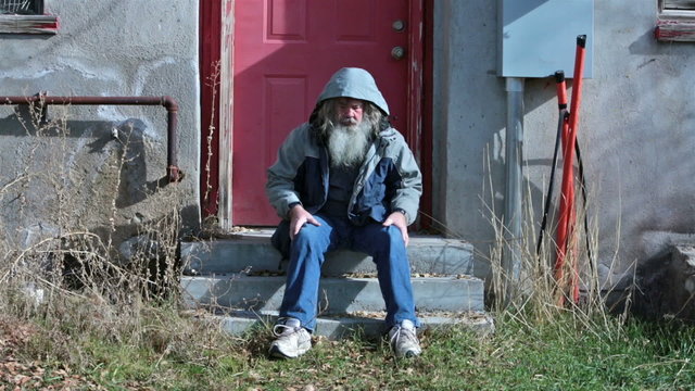 Homeless man cold sad walks away from steps HD 0141
