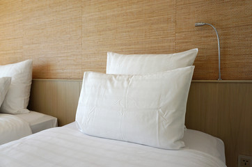 Fototapeta na wymiar Double white pillow on white bed sheet