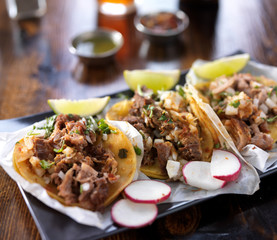 mexican tacos with limes and radish slices