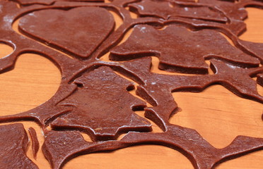 Dough for gingerbread in shape of heart, star and christmas tree
