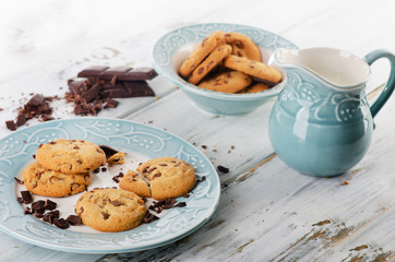 Chocolate chip cookies with milk  on a wooden table.