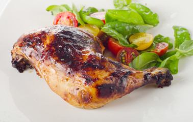 Roasted chicken leg with fresh salad.