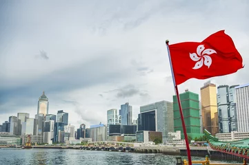 Fotobehang Hong Kong Flag with urban background © leeyiutung