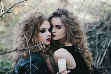 Two vintage witches gathered eve of Halloween