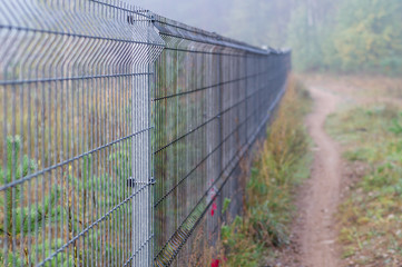 Fototapeta premium Long security metal rod fence