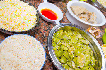 Bowls of different ingredients spread out on granite surface