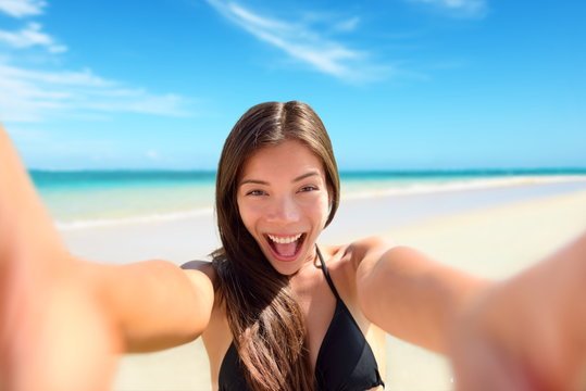 Selfie fun woman taking photo at beach vacation