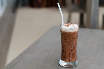 iced cocoa in a glass on wood background