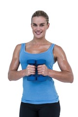 Muscular woman exercising with dumbbells 