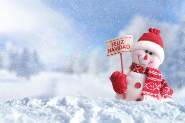 Snowman with a placard Feliz Navidad on the snow