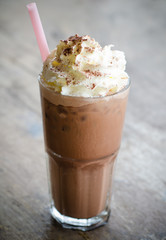 iced cocoa in a glass on wood background, vintage cocoa