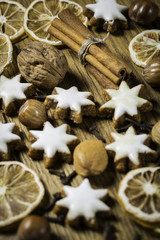 christmas background with ginger-breads, fruits, herbs and spices