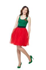 Happy teenage girl wearing summer skirt standing on white background. Smiling pretty brunette lady model posing in studio