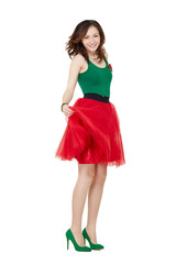 Studio body portrait of cheerful young woman wearing a tulle red skirt and high heels.