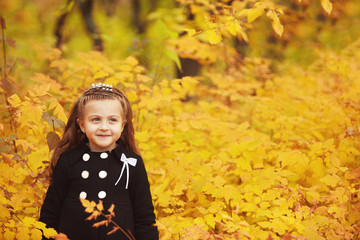 Autumn portrait of cute child girl wearing fashion warm coat and looking at copyspace