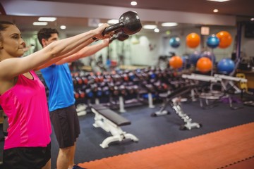 Fit couple working out in weights room