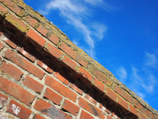 Bottom view on a fragment of an old brick fence