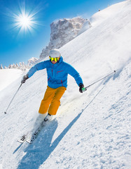 Fototapeta na wymiar Skier skiing downhill in high mountains