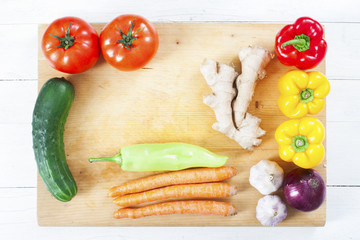 Healthy food background. Yellow and red pepper on chopping board.