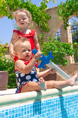 Happy children playing in the pool