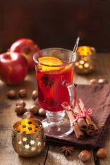 glass of mulled wine with orange and spices, christmas decoratio