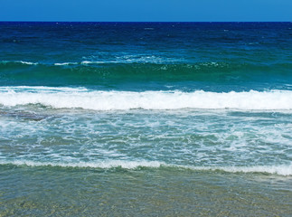Image of blue waves on the beach.