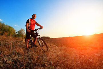 Fototapeta na wymiar Mountain Bike cyclist riding single track at sunrise
