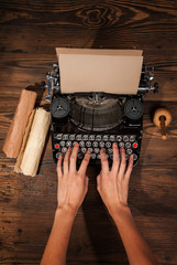 Woman typing on an old typewriter