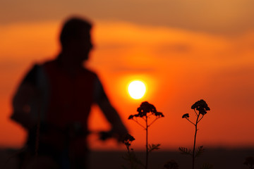Silhouette of a man on muontain-bike
