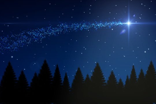 Shooting star over forest at night