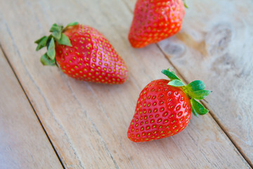 Fresh red strawberries on wooden table