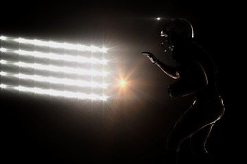 Fototapeta premium Silhouette of sportsman playing american football