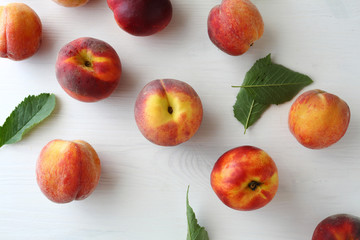 fresh ripe peaches and green leaves