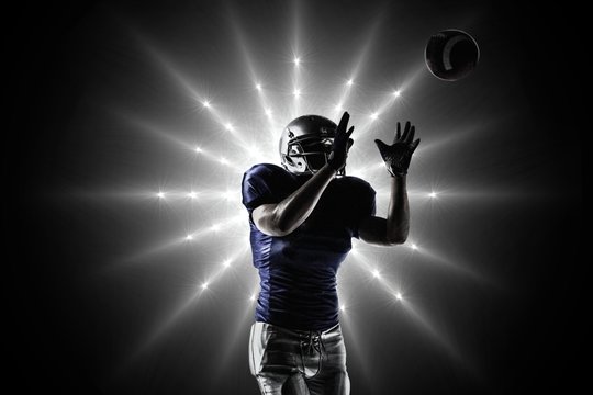 Composite image of american football player catching ball