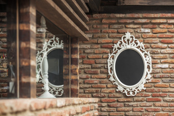 The mirror on the old brick wall