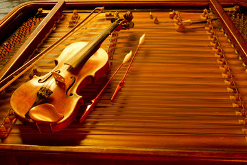 two music string instrument  in gold light on cimbalom