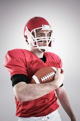 Composite image of american football player with ball 