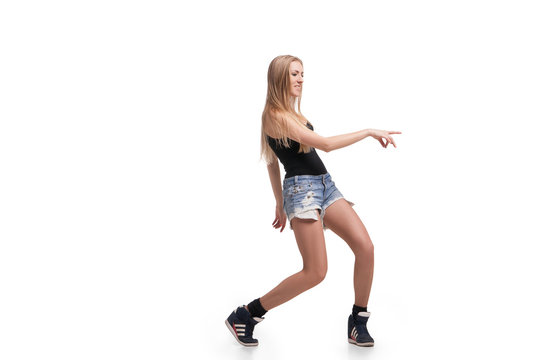Young beautiful dancer posing on studio background