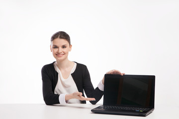 Young business woman presenting laptop