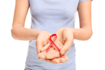 Fototapeta premium Female hands holding an AIDS ribbon
